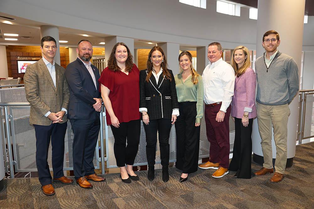 Managament and Information Systems Advisory Board standing on the third floor of McCool Hall's Atrium for Spring meeting on March 1, 2024. 