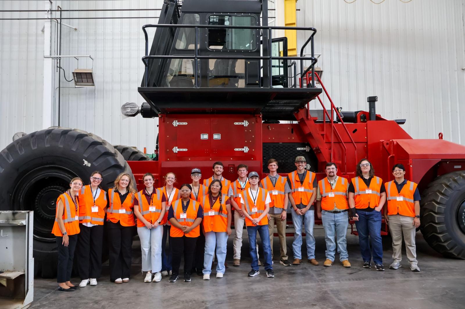 students in front of machinery