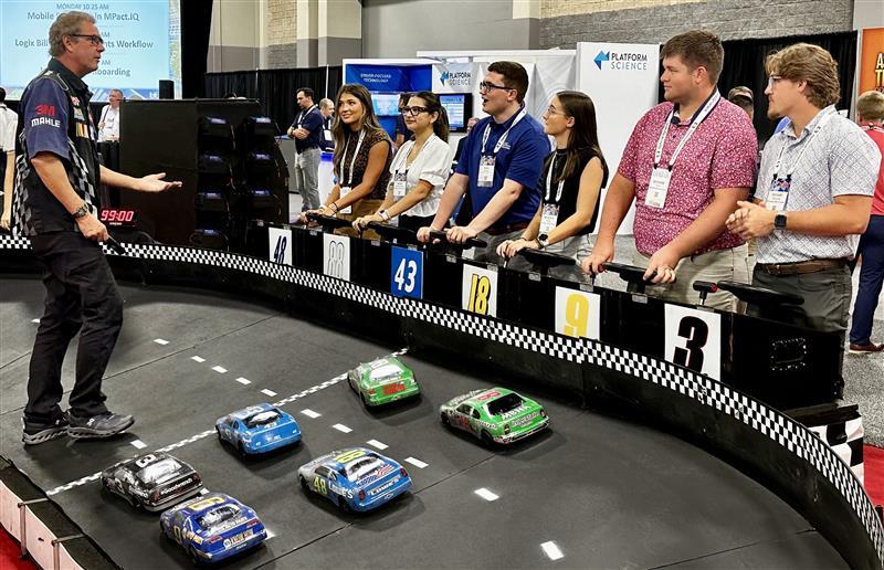 students watching cars race