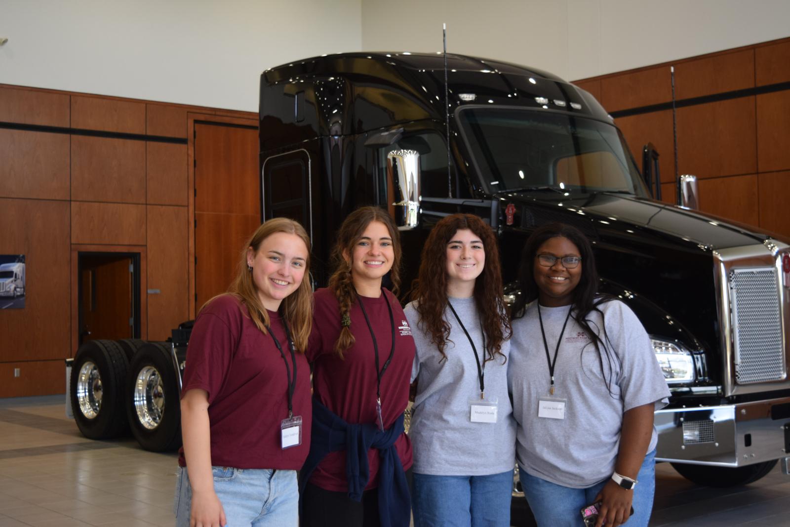 students in front of a truck